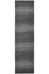 The Antrachite Shadows Black Rug - M497A features a modern gradient from dark gray edges to a lighter gray center with subtle texture, making this rectangular rug a stylish minimalist choice for contemporary spaces.