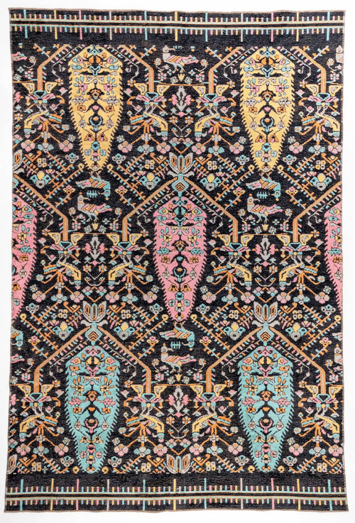 Load image 1 in gallery view. Midnight Bazaar area rug with black ground and vibrant pink, yellow, and turquoise paisley boteh motifs