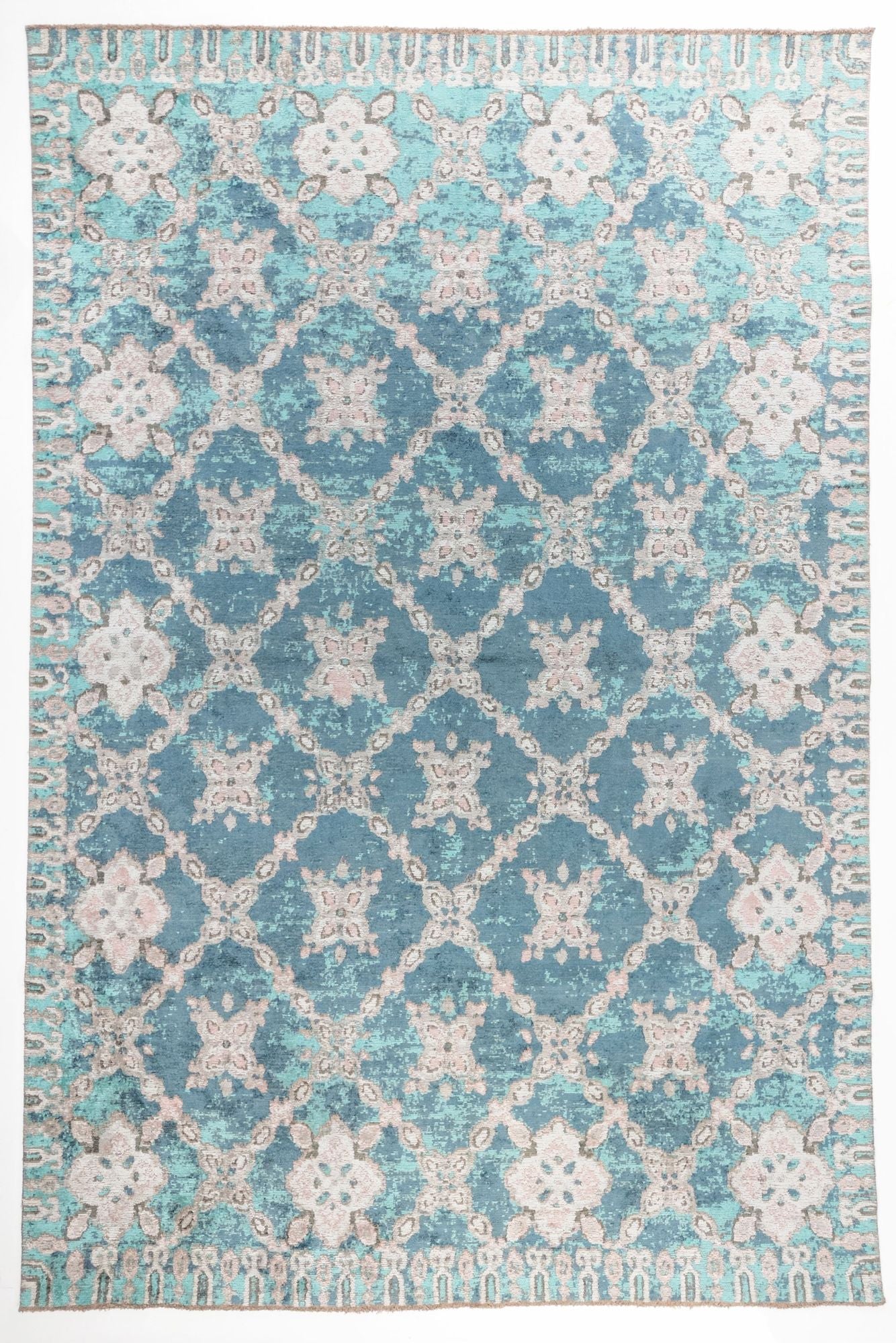 Ocean Trellis area rug with deep teal blue field and ivory lattice pattern with distressed floral motifs