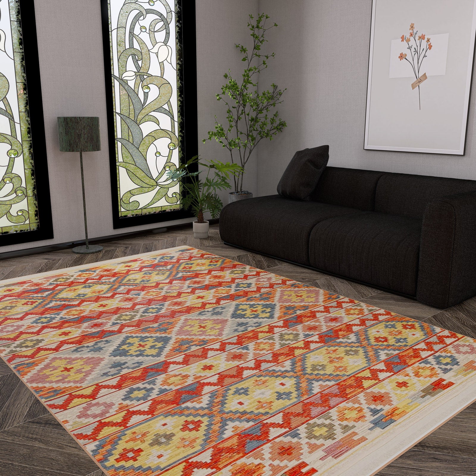 A modern living room with a dark sofa, floor lamp, leafy plant, and wooden floors features the Aqua Flow - Kilim - NMD02 rug for a pop of blue, complemented by stained glass windows with floral designs and a framed botanical print.