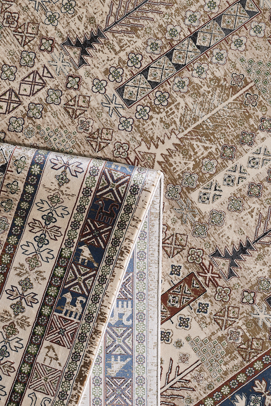 A close-up of the Archery Elegance Premium Rug - Earthy - 2183B shows its beige and brown geometric and floral patterns, with one corner folded to reveal the intricately detailed reverse side.