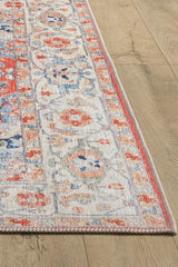 A close-up of the Ardentis Medallion Washable Rug - LCC3002 (Outlet) US, featuring intricate floral and geometric patterns in red, blue, and beige on a light wood floor.