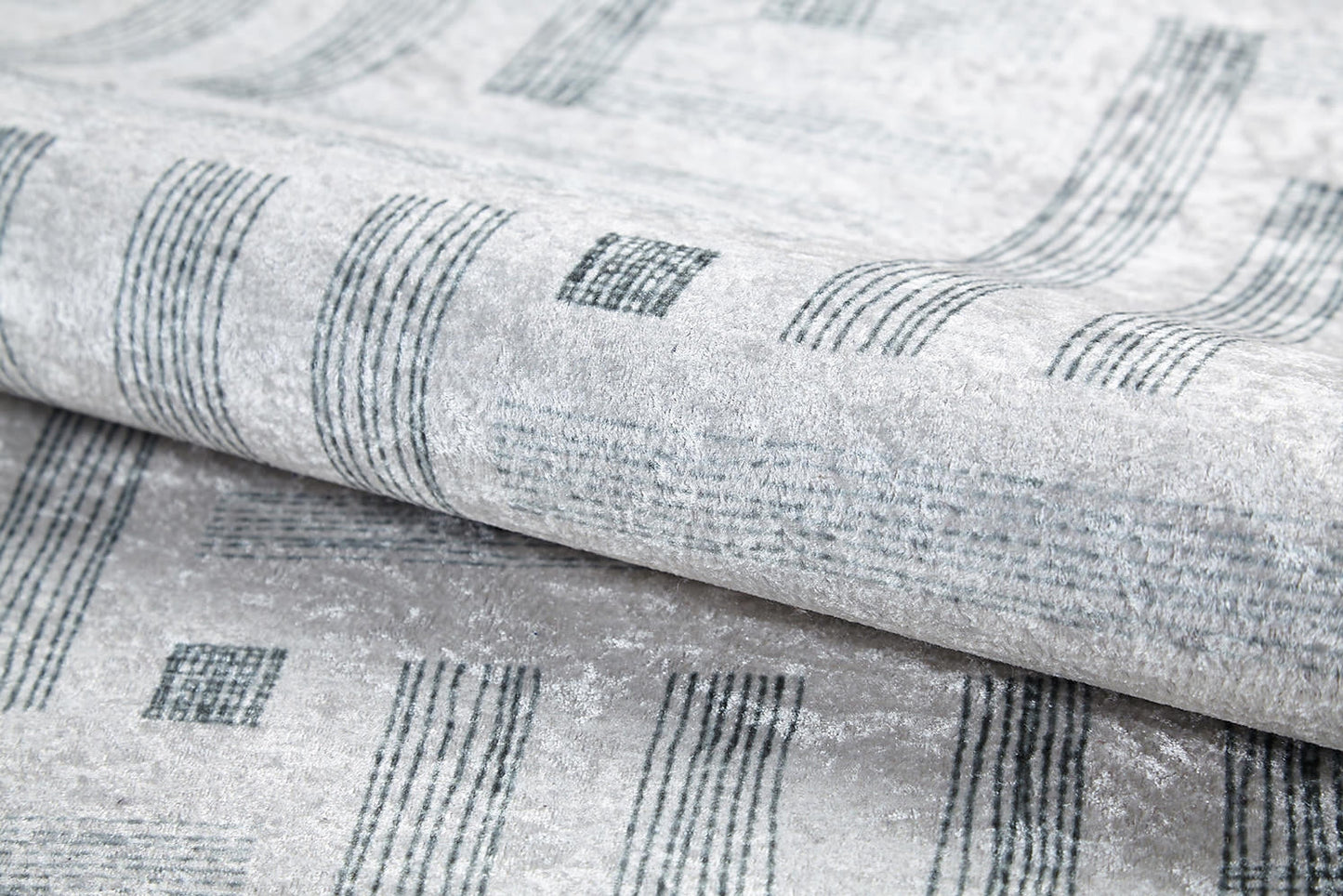 Close-up of the Art Deco Chic - Washable Rug - JR1832 (Custom Size) in light gray, featuring a modern design with dark gray lines and rectangles, highlighting its texture and sheen—perfect for high-traffic spaces.