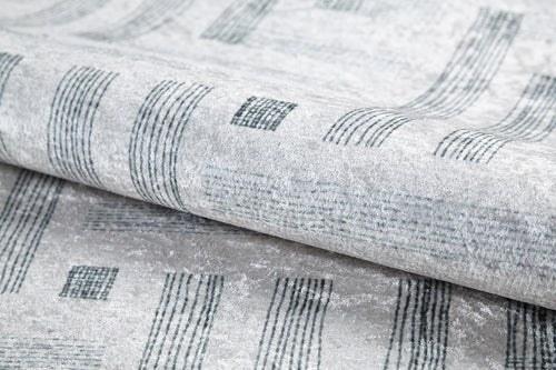 Load image 1 in gallery view. Close-up of the Art Deco Chic - Washable Rug - JR1832 (Custom Size) in light gray, featuring a modern design with dark gray lines and rectangles, highlighting its texture and sheen—perfect for high-traffic spaces.
