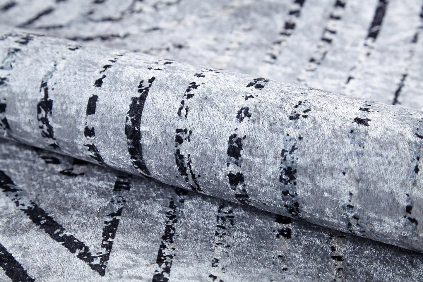 A close-up of the Art Deco Empress - Washable Rug - JR1867 (Custom Size) shows its gray-anthracite tones, irregular black lines, and abstract geometric patterns that create a modern, artistic look.