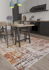Modern kitchen and dining area with black cabinets, light wood furniture, a vase of purple flowers on the table, two blue pendant lights, and the Artistic Abstraction - Washable Rug - JR775 (Custom Size) in orange, yellow, and cream tones on the floor.