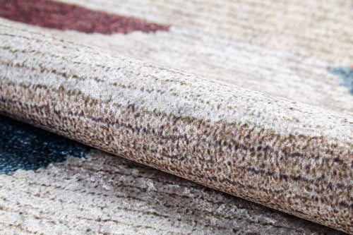 Load image 1 in gallery view. A close-up of the Asymmetrical Wonder - Washable Rug - JR1725 (Custom Size) shows its beige and brown textured surface with blue and red accents, soft fibers, and subtle patterns—perfect for high-traffic or allergy-sensitive spaces.