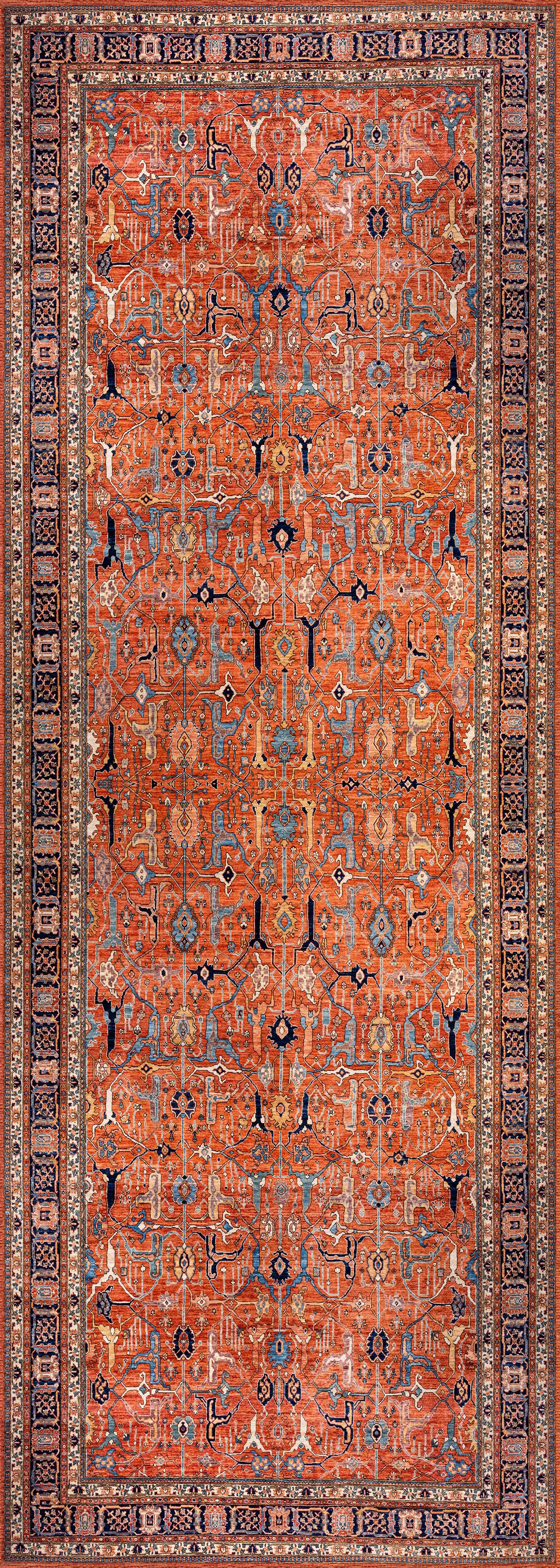 The Aurelius Coral Washable Rug - LCC3005 is a rectangular flat weave featuring an intricate geometric pattern in red, blue, and beige. Durable and ideal for high-traffic areas, it displays repeating motifs framed by decorative borders.