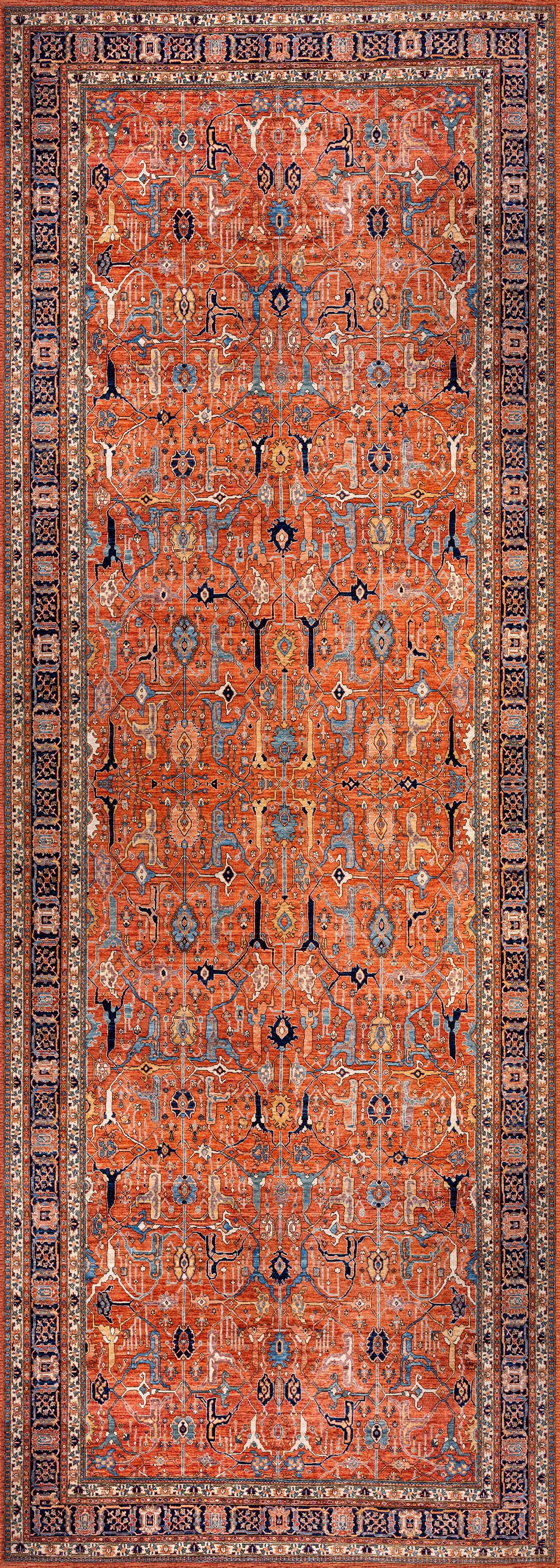 The Aurelius Coral Washable Rug - LCC3005 is a rectangular flat weave featuring an intricate geometric pattern in red, blue, and beige. Durable and ideal for high-traffic areas, it displays repeating motifs framed by decorative borders.