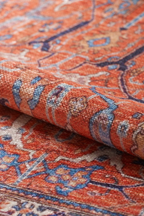 Bild 1 in Galerieansicht laden. A close-up of the Aurelius Coral Washable Rug - LCC3005 (Custom Size) shows intricate red, blue, and beige patterns with floral and geometric shapes, making it a stylish and practical choice for high-traffic areas.