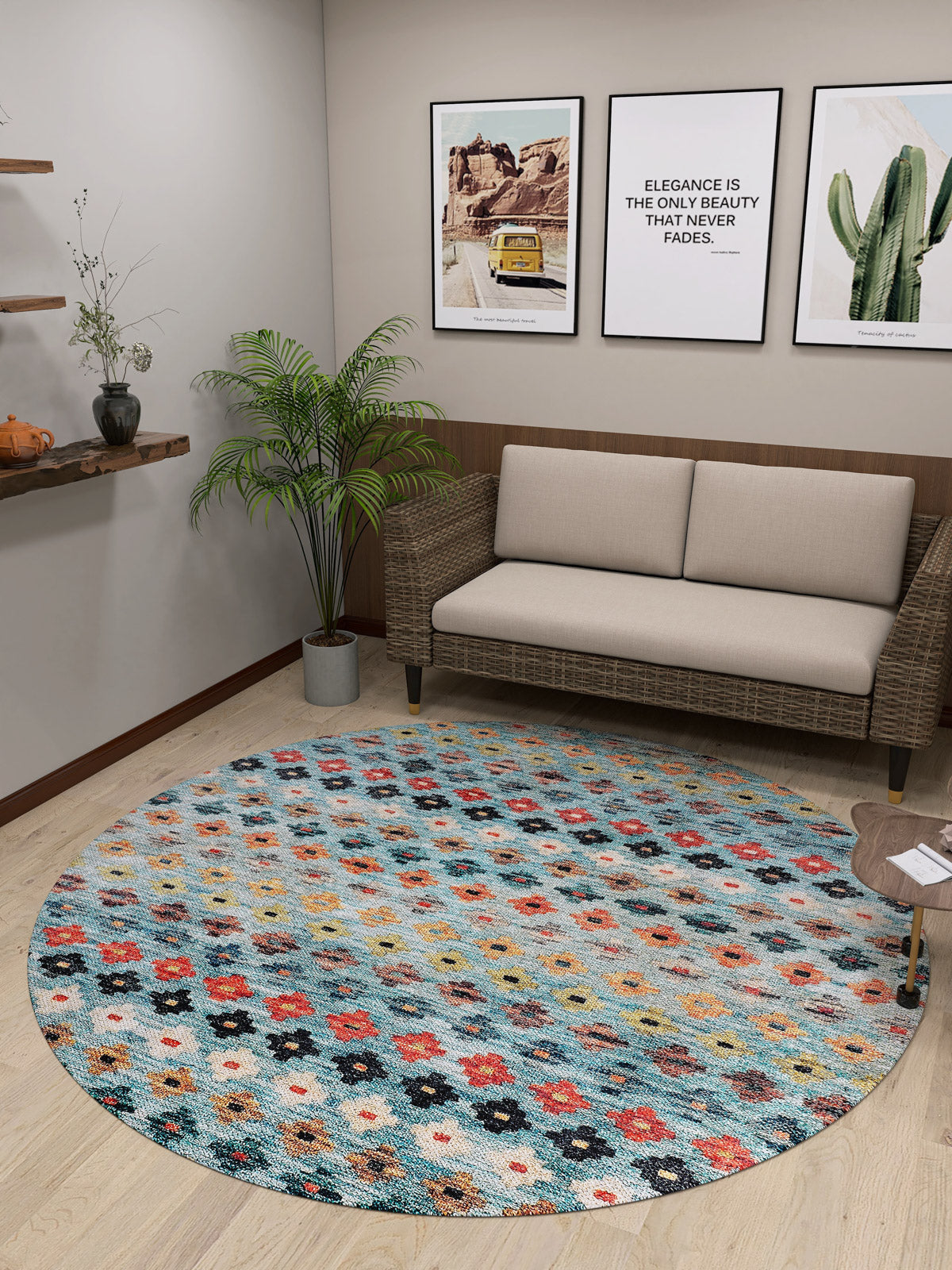A cozy, modern room featuring a light sofa, wicker loveseat, Aztec Ambience Washable Rug (JR1086), potted plant, cactus print wall art, small wooden table, and shelf decor—ideal for high-traffic areas.