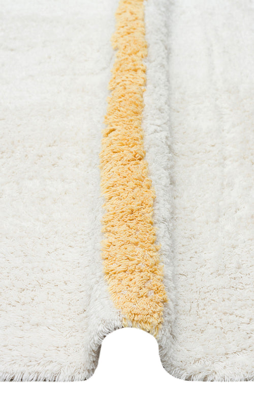 Load image 1 in gallery view. The Baby Breeze - Washable Shaggy - CBN01 is a white, fluffy rug with a raised yellow stripe and U-shaped notch—washable and perfect for adding playful style to any kids room.