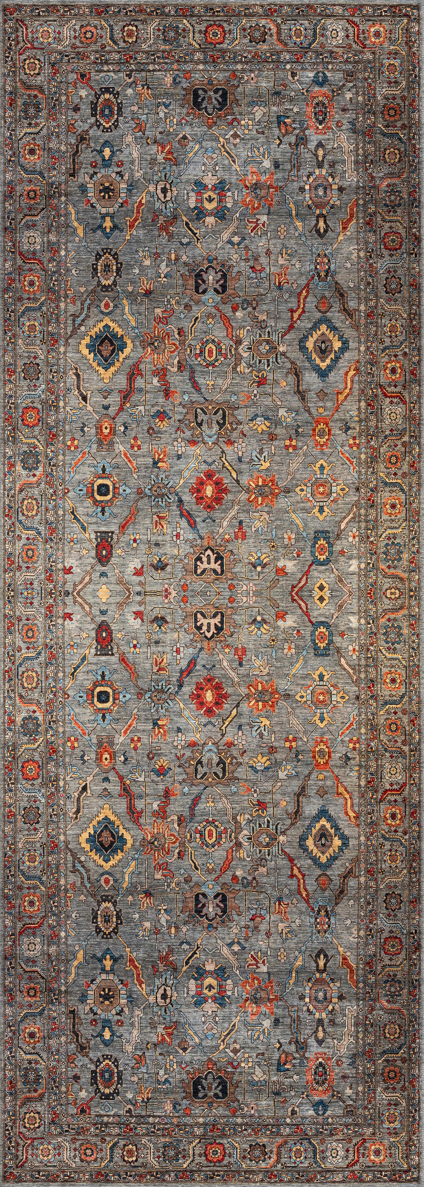 The Bellaris Gray Washable Rug - LCC3003 is a rectangular rug with an intricate geometric and floral pattern in blue, red, gold, and cream, detailed border, symmetrical design, and ideal for allergy-sensitive spaces.