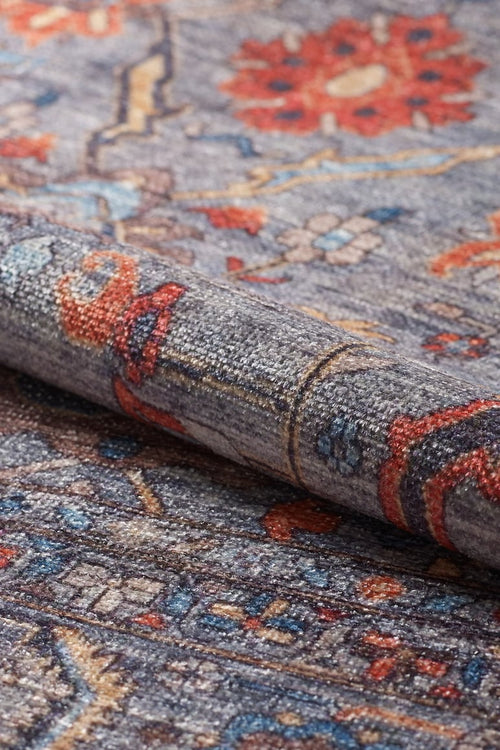 Load image 1 in gallery view. A close-up of the Bellaris Gray Washable Rug - LCC3003 (Outlet) US displays its textured flat weave and intricate red, blue, yellow, and gray patterns.