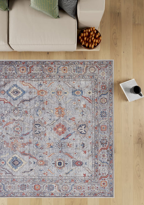 Bild 1 in Galerieansicht laden. The Bellaris Gray Washable Rug - LCC3003 (Custom Size) lies on a light wood floor next to a beige sofa, a pillow, a bowl of pastries, and an open book with a cup of coffee.