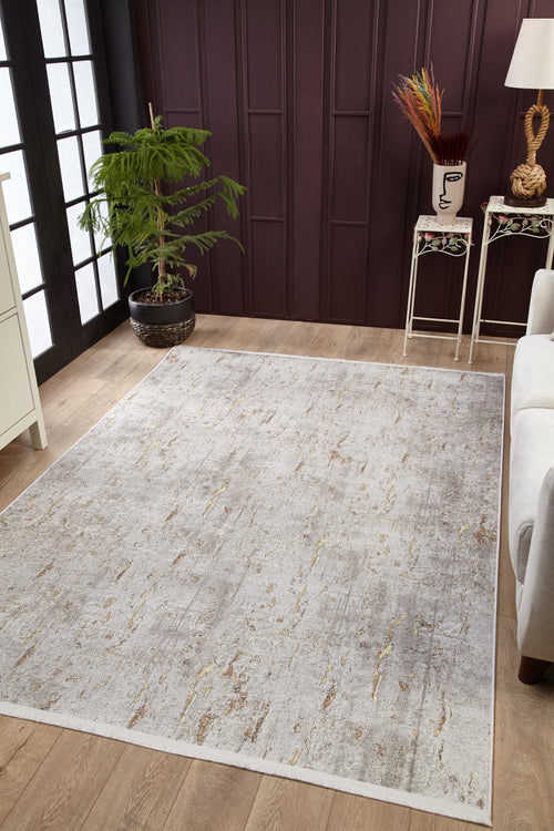 Load image 1 in gallery view. A modern living room features the Berry Blossom - Washable Rug - JR1818 (Custom Size) on wooden floors, a white sofa, a potted plant by the window, and a side table with decor and a face-shaped vase against a dark paneled wall.