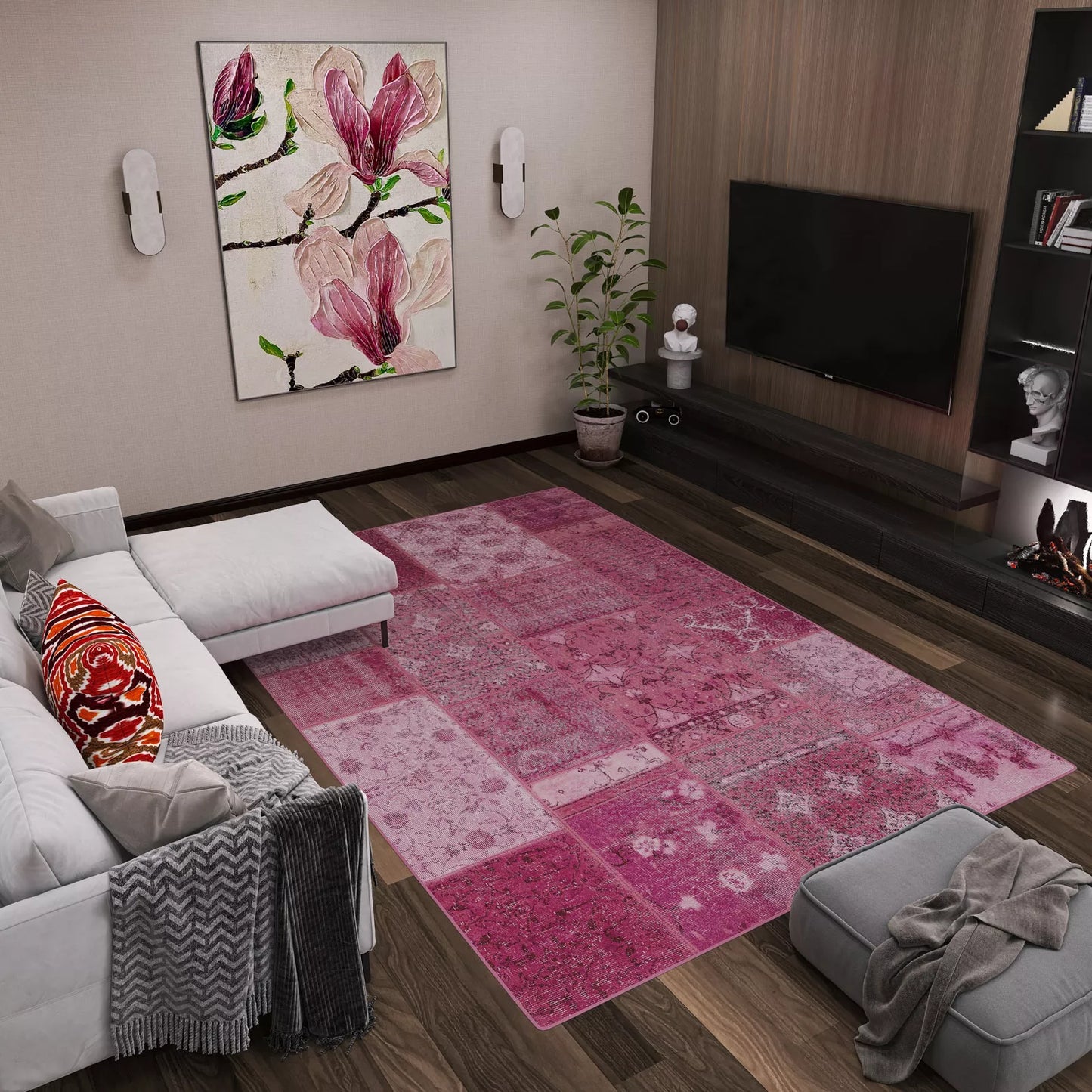 Modern living room with a white sofa, gray ottoman, the Berry Patchwork - Washable Rug (JRN1040)—perfect for high-traffic areas—large floral wall art, potted plant, flat-screen TV above a dark media unit with décor and small fireplace.
