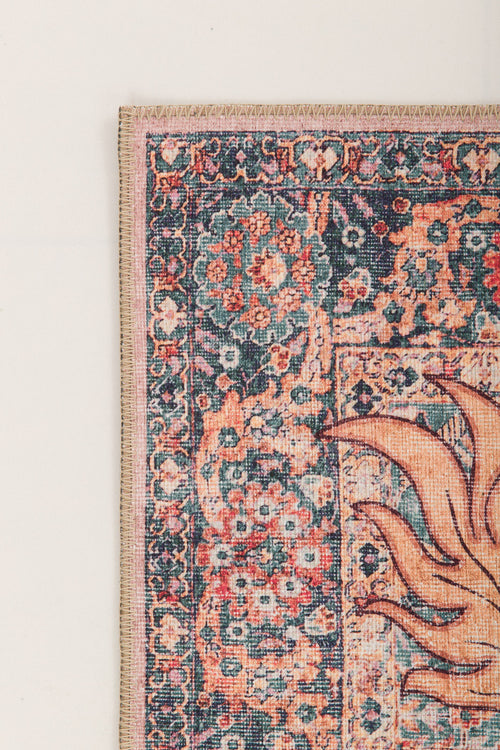 Load image 1 in gallery view. A close-up of the Blazefang Myth - Washable Rug - JR0049 shows its detailed floral border in blue, pink, and orange with part of an abstract sun-inspired geometric pattern on the right.