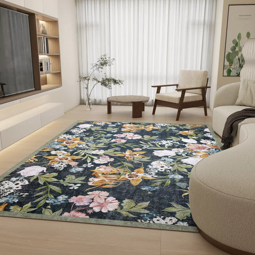 Load image 1 in gallery view. A modern living room with light wood floors, neutral furniture, a custom-size Bloom Garden - Washable Rug - JRN1039 featuring colorful flowers, a TV on a low unit, a potted plant, and large windows with sheer white curtains.