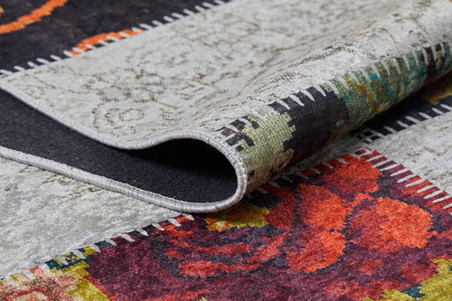 Load image 1 in gallery view. A close-up of the Blooming Paradise - Washable Rug - JR188 (Custom Size) shows its folded corner, stitched edges, and red, orange, green, and gray floral and abstract designs—ideal for adding style to high-traffic areas.