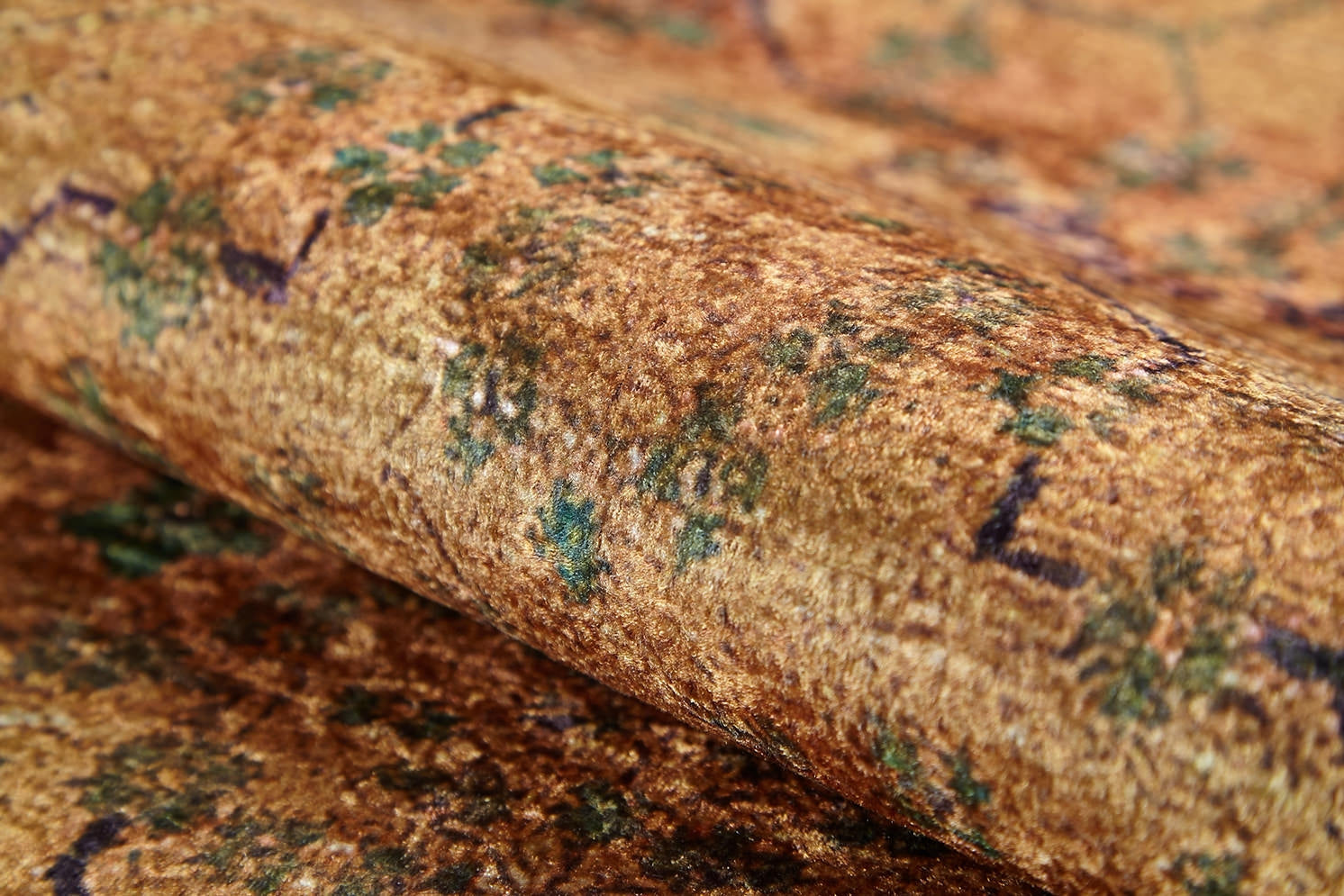 A close-up of the Blossom Breeze - Washable Rug - JR1752 (Custom Size) reveals its textured brown and gold surface with hints of green and purple, a soft feel, and a vintage look—perfect for high-traffic areas.