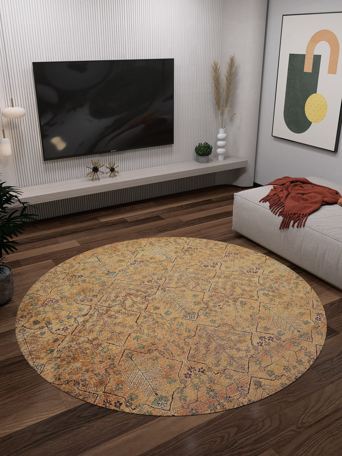 A modern living room features the Blossom Breeze - Washable Rug - JR1752 (Custom Size) on dark wood floors, a wall-mounted TV, low console, plants, abstract art, and a chaise lounge with an orange blanket—ideal for high-traffic spaces.