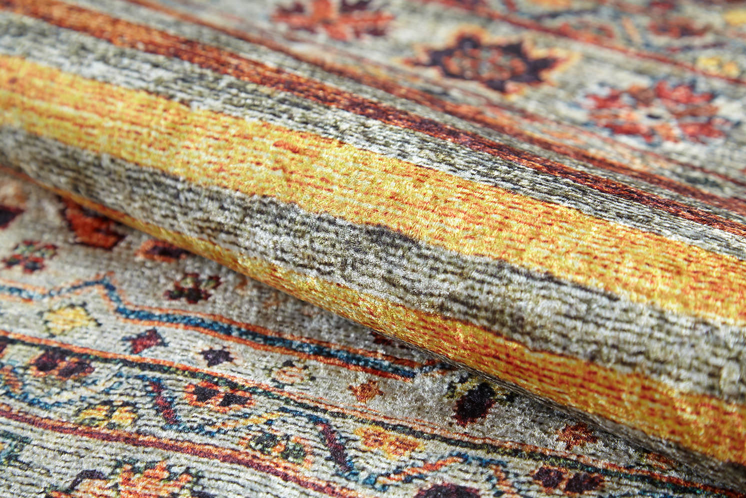 A close-up of the Bohemian Bouquet - Washable Rug - JR5090 (Custom Size) highlights its intricate multicolor patterns in yellow, orange, red, and brown with detailed flat weave texture clearly visible.