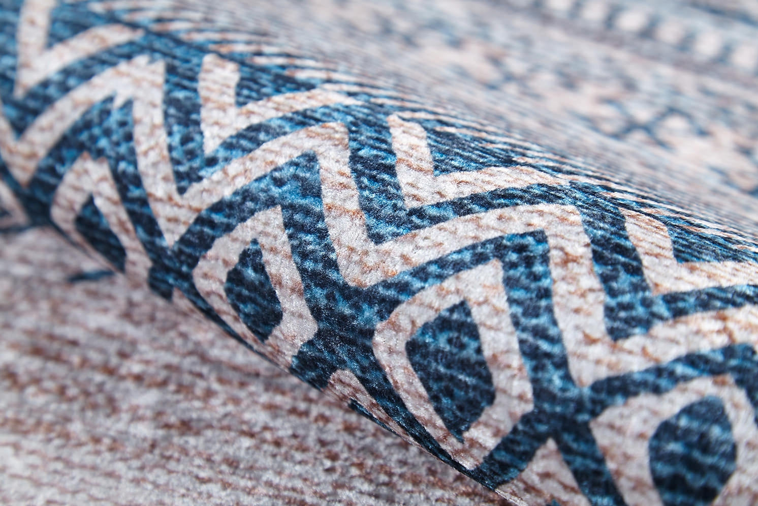 A close-up of the Bohemian Nights - Washable Rug - JR1585 (Custom Size), featuring a soft flat weave with blue and beige geometric zigzags and diamonds. The sharp pattern makes it ideal for high-traffic areas.