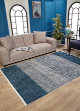A modern living room with a beige sofa, open magazine, indoor plant, blue accent wall, arched black-framed windows, and the Bohemian Retreat - Washable Rug - JR1589 (Custom Size), perfect for high-traffic areas.