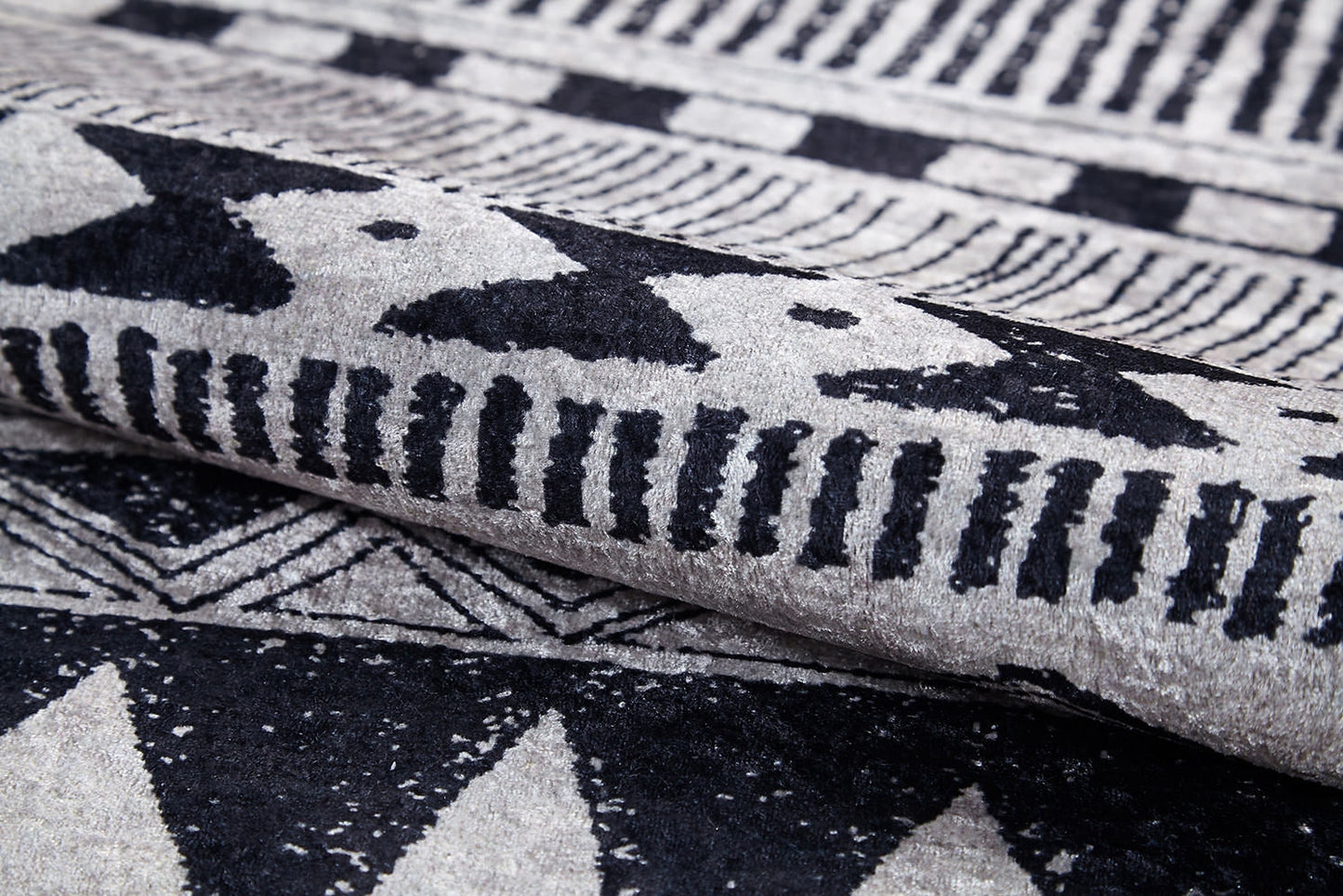 Close-up of the Bohemian Sunrise - Washable Rug - JR1713 (Custom Size), showcasing its bold black and white geometric patterns—triangles, lines, and dots—perfect for adding texture and style to high-traffic areas.