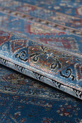 A close-up of the Bohemian Tracery Rug - Blue - 2221B displays its intricate multicolored designs, rolled edge, and detailed decorative texture.