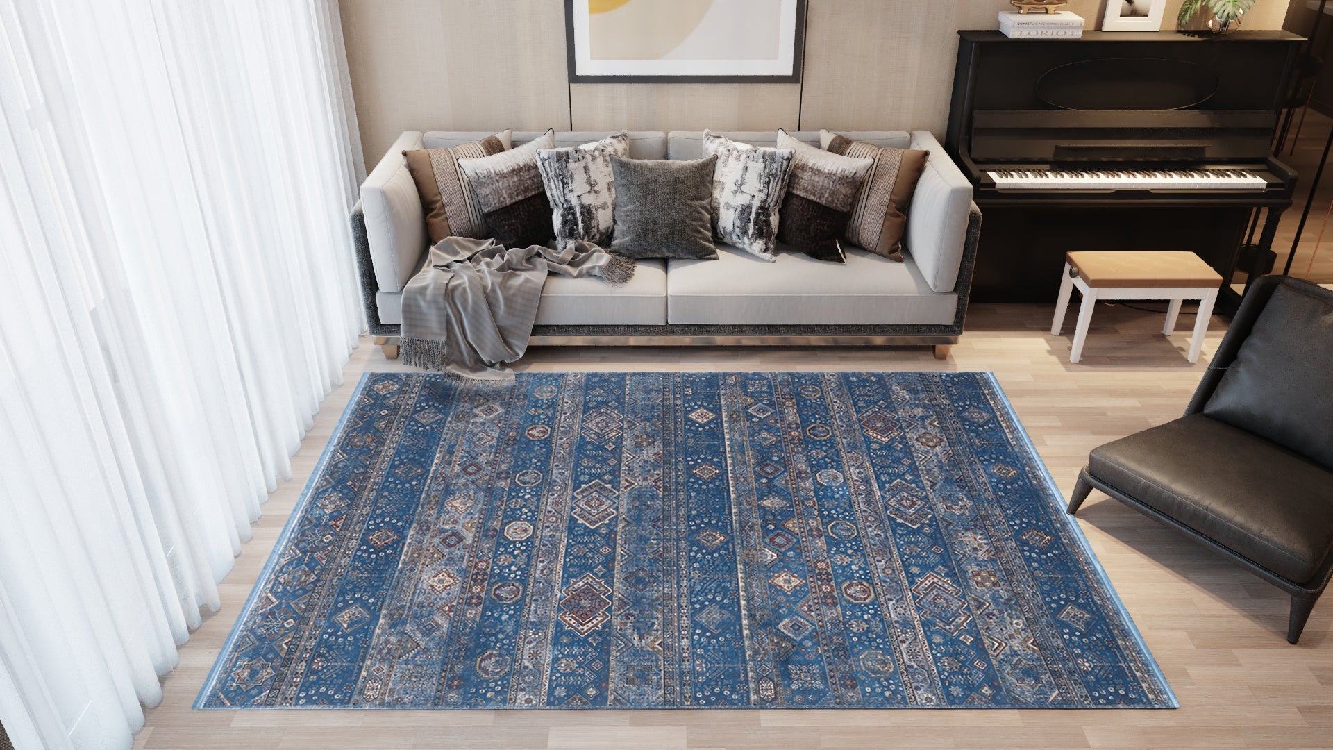 A modern living room with a gray sofa, gray throw blanket, black piano with white stool, and the Bohemian Tracery Rug - Blue - 2221B on light wood flooring. Sunlight streams in through sheer curtains.