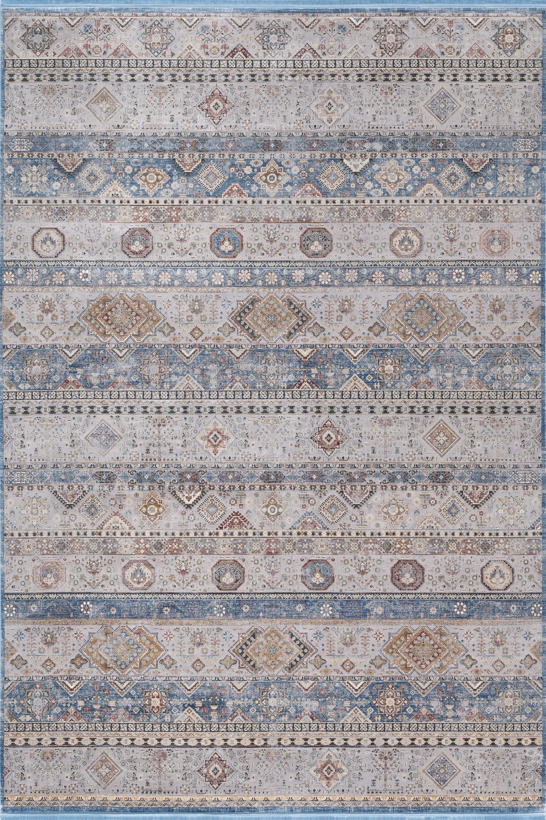 The Bohemian Tracery Rug - Grey - 2221C is a large machine-made rug with geometric and floral patterns in blue, beige, cream, and brown stripes for a distressed, vintage style.