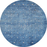 The Bohemian Whirlwind - Washable Rug - JR1989 is a round blue rug with a textured look and white and black geometric diamond patterns, ideal for high-traffic areas and easy to clean.
