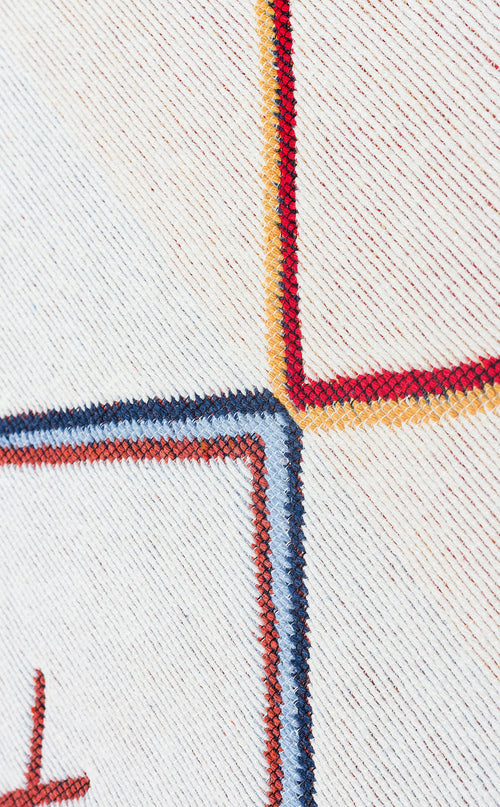 Load image 1 in gallery view. Close-up of Boho Charm - Washable Reversible Kilims - AR21: white textured fabric featuring colorful embroidered red, yellow, and blue geometric squares intersecting at one corner, evoking a flatwoven rug style.