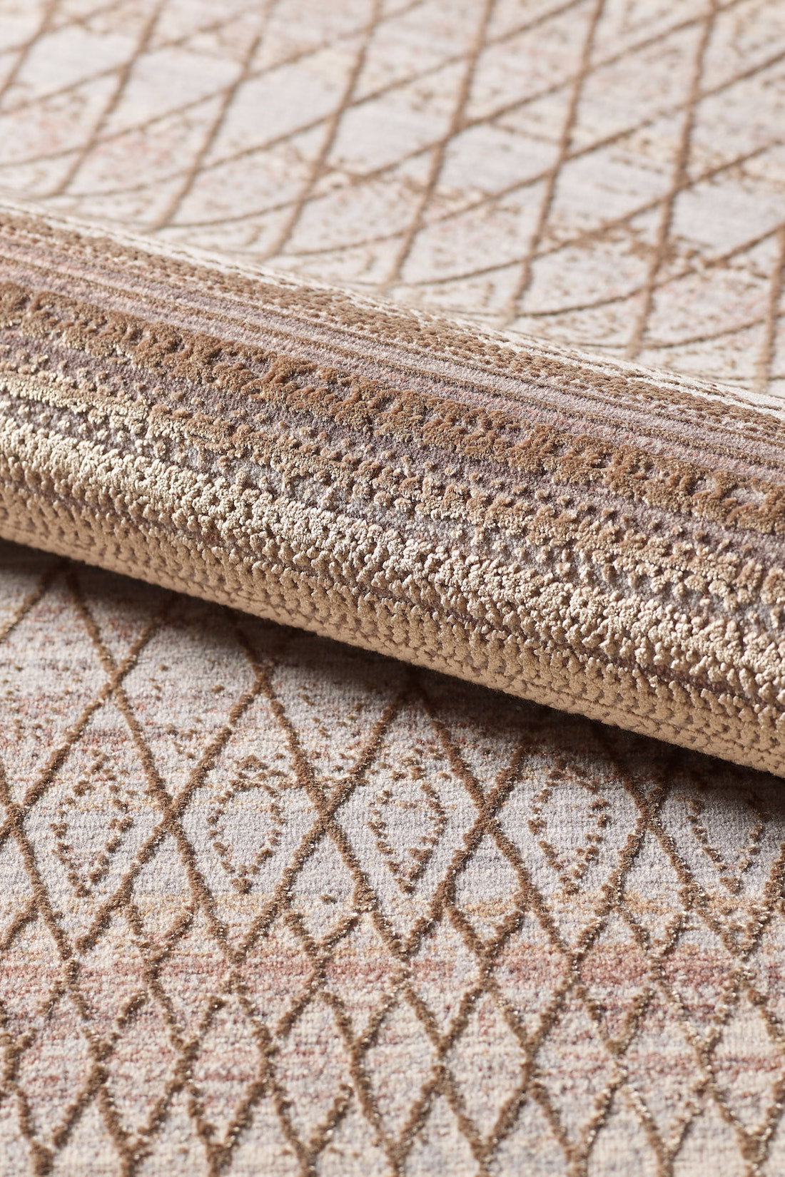 Close-up of the Boho Sunset Trellis Rug - HRD004, a machine-made beige and light brown area rug featuring textured fibers and an intricate diamond geometric pattern.