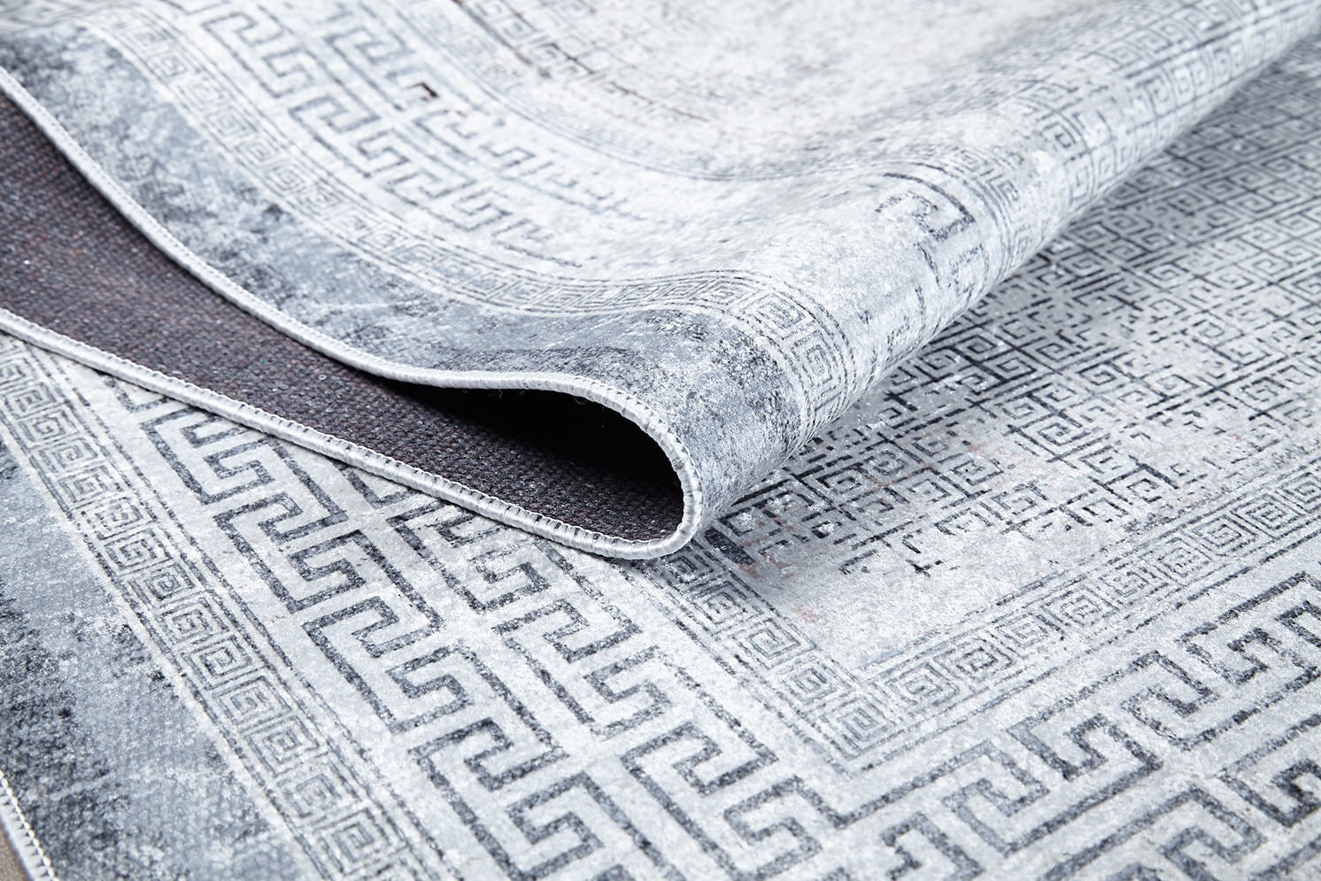 A close-up of the Bold Borderline - Washable Rug - JR1984 (Custom Size) shows its light gray Greek key pattern with darker geometric motifs and visible texture, making it ideal for high-traffic areas.