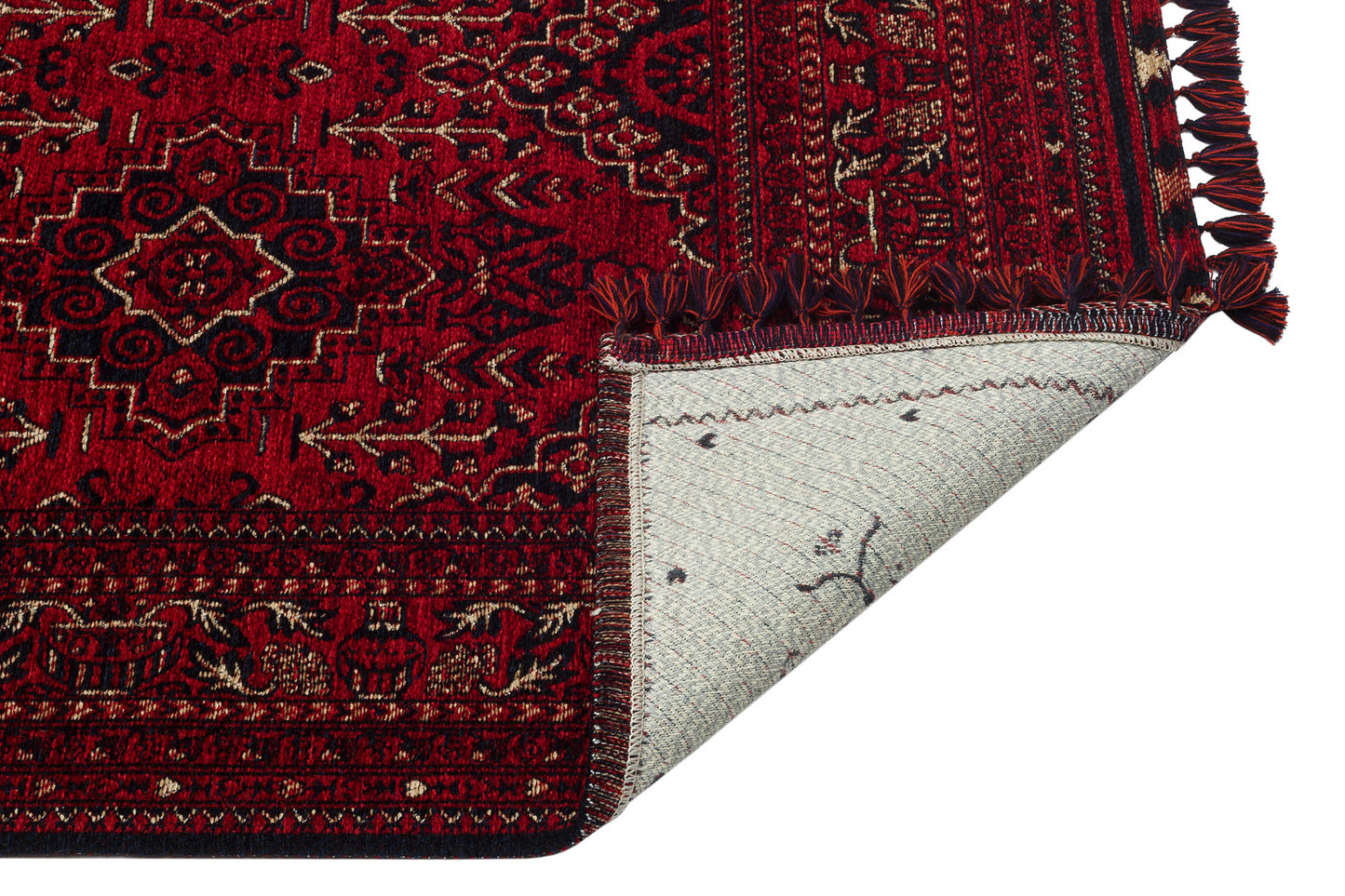 The Bold Thread - Kilim - BHR05 is a red, machine-made rug with intricate Turkish geometric and floral patterns, shown partly folded to display its light underside and fringed edge.