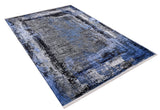 Bold and Minimalist - Washable Rug - JR1229 (Custom Size) is a rectangular rug featuring an abstract pattern in blue, gray, black, and white with a faded look. Shown at an angle against a white background; ideal for high-traffic areas.