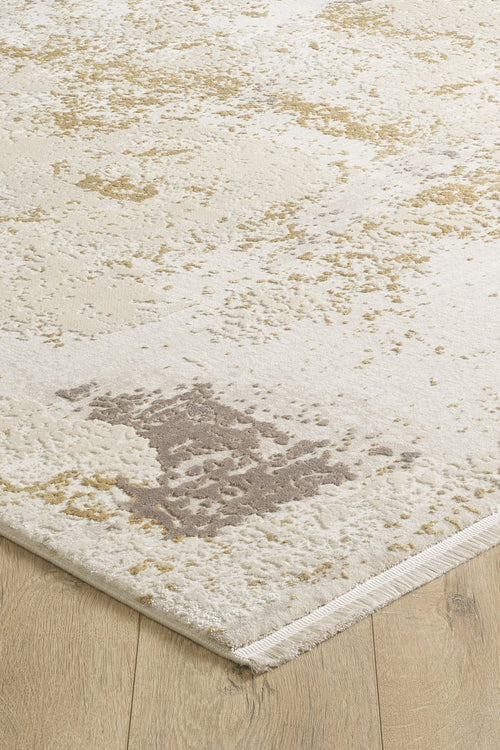 Load image 1 in gallery view. A close-up of the Bright Swirls Contemporary Rug - M657F displays its abstract beige, cream, and light brown pattern on a light wood floor, highlighting the modern rug’s edge and textured surface.