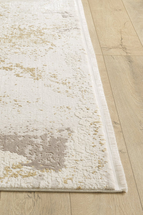 Load image 1 in gallery view. A close-up of the Bright Swirls Contemporary Rug - M657F shows its abstract beige, light gray, and cream pattern on a light wood floor. This machine-made rug has subtle textured details and finished edges.