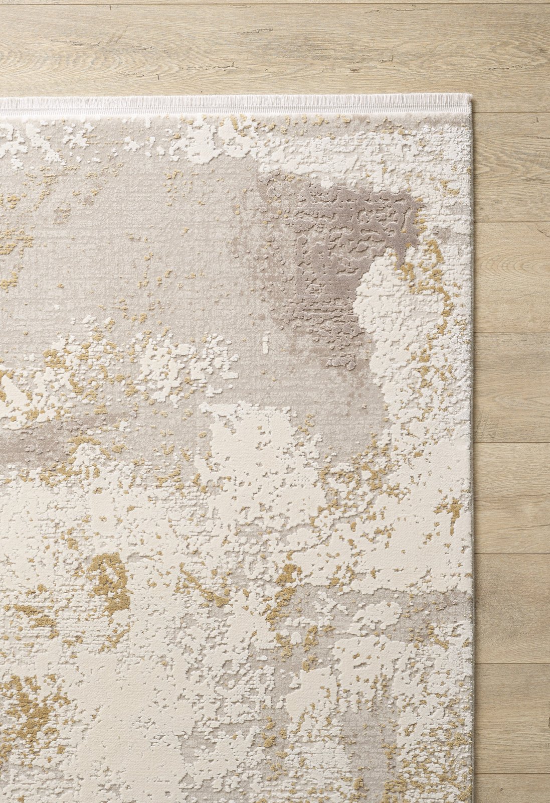 The Bright Swirls Contemporary Rug - M657F features an abstract cream, beige, taupe, and gold pattern with a white border and painterly texture, displayed on a light wooden floor. Its machine-made design adds a modern touch to any space.