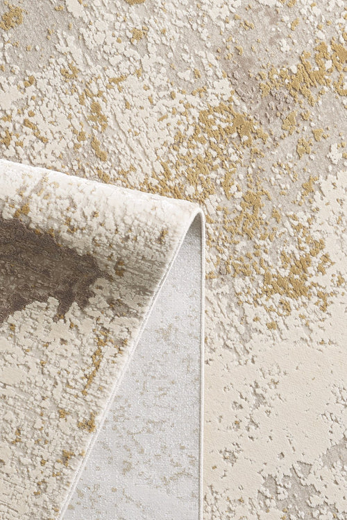 Load image 1 in gallery view. A close-up of the Bright Swirls Contemporary Rug - M657F shows its folded corner, highlighting beige, cream, brown, and gold abstract patterns along with a visible soft, varied pile and machine-made weave.