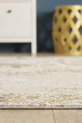 A close-up of the Bright Swirls Contemporary Rug - M657F with subtle patterns on a wooden floor, featuring part of a white cabinet on the left and a decorative yellow cutout stool on the right in the background.