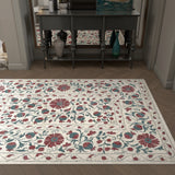 Floral patterned rug on a wooden floor with a sideboard in the background