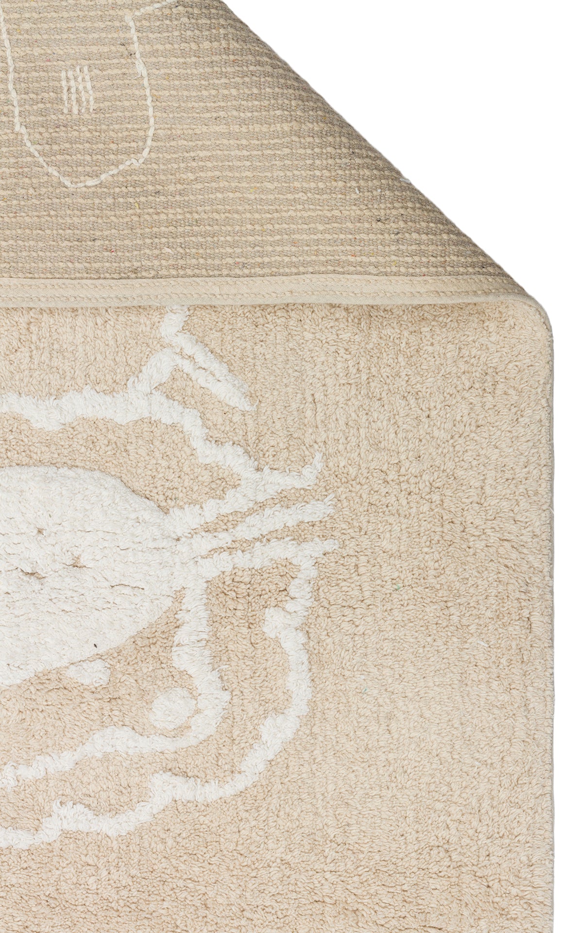 The Calm Nest - Washable Shaggy - CBN16 is an ultra-soft cream beige cotton rug featuring a white abstract animal design, shown partially folded to display its textured underside.