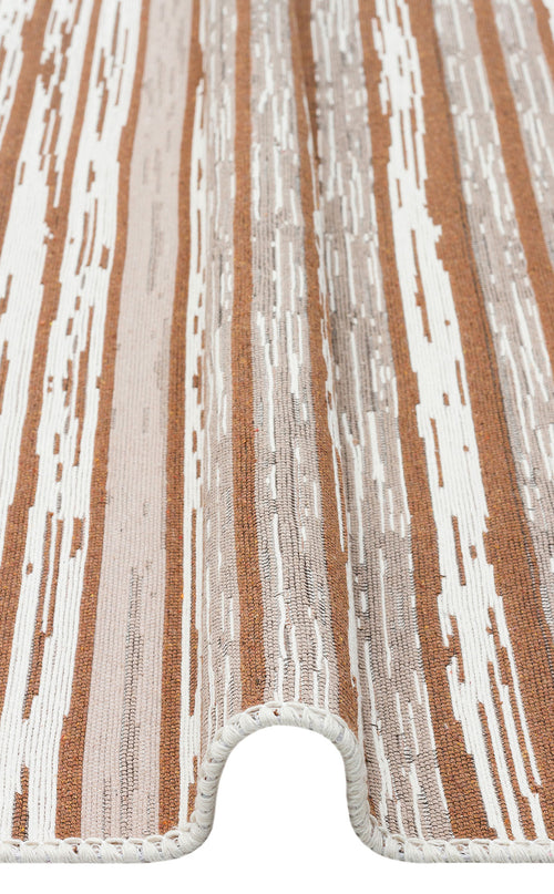 Load image 1 in gallery view. A close-up of the Calm Thread - Washable Double-Sided Kilims - AR27 showcases its neutral wavy brown, beige, and cream stripes, curved folded edge, woven texture, and stitched edging.