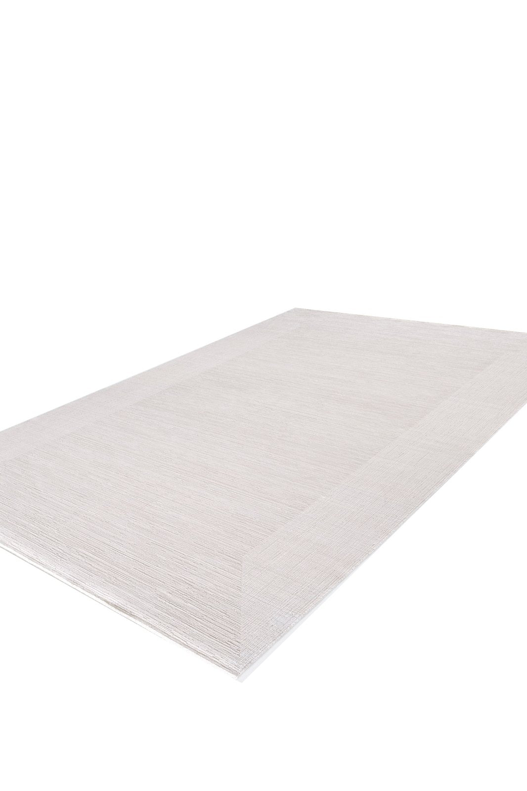 The Candlelight Comfort Modern Ivory Rug - EW2824 is a rectangular, machine-made rug in a neutral hue, featuring a subtle border. Shown angled on a white background to display its texture and thin profile.