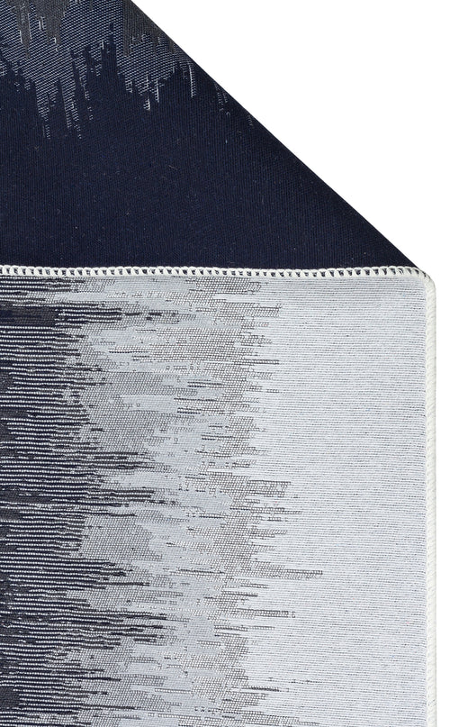 Load image 1 in gallery view. Close-up of the Charcoal Frame - Washable Double-Sided Kilims - AR40: features black and white abstract patterns, neat stitching on the edge, and a dark navy blue underside.