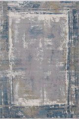 The ChromaBurst Premium Rug - Blue - MT176 is a machine-made rug with a distressed abstract pattern in blue, gray, white, and gold hues, featuring an irregular painterly square and border design for a modern touch.